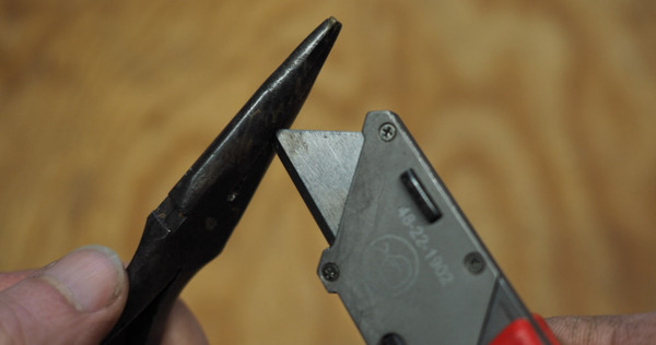 Snapping off 1/4" with a pair of pliers.
